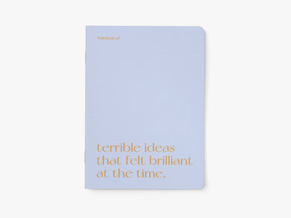 Notitieboek A5 van typealive, lichtblauw met oranje tekst 'terrible ideas that felt brilliant at the time.', vooraanzicht