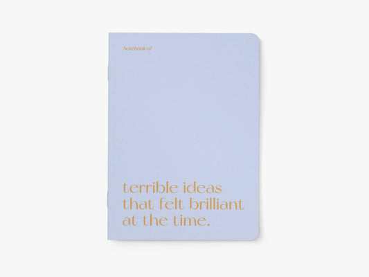 Notitieboek A5 van typealive, lichtblauw met oranje tekst 'terrible ideas that felt brilliant at the time.', vooraanzicht