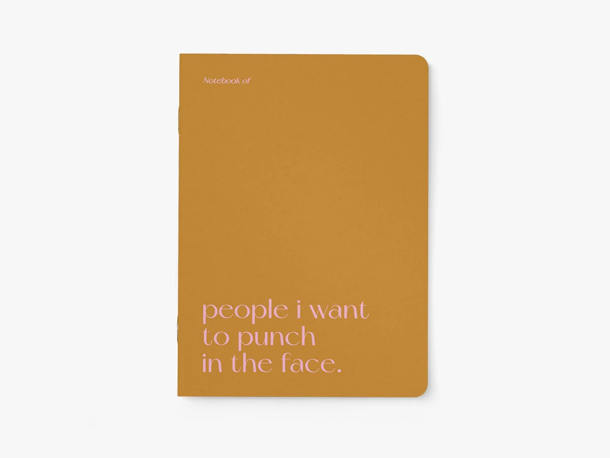 Notitieboek A5 van typealive, okergeel met witte tekst 'people i want to punch in the face.', vooraanzicht