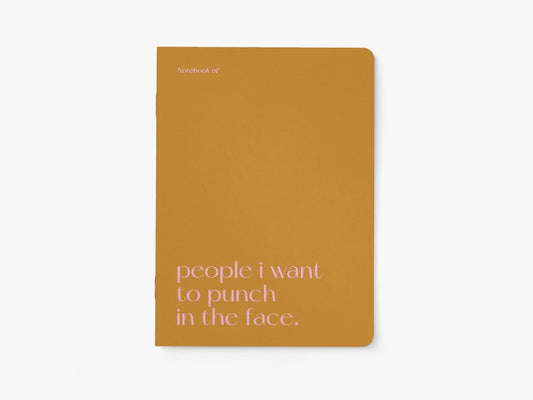 Notitieboek A5 van typealive, okergeel met witte tekst 'people i want to punch in the face.', vooraanzicht
