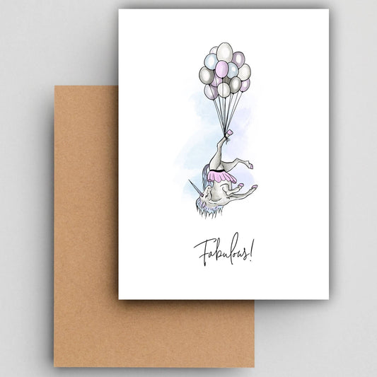 Wenskaart Fabulous unicorn van Studio Raquelle: een eenhoorn die ondersteboven aan een tros ballonnen hangt, met de tekst Fabulous!