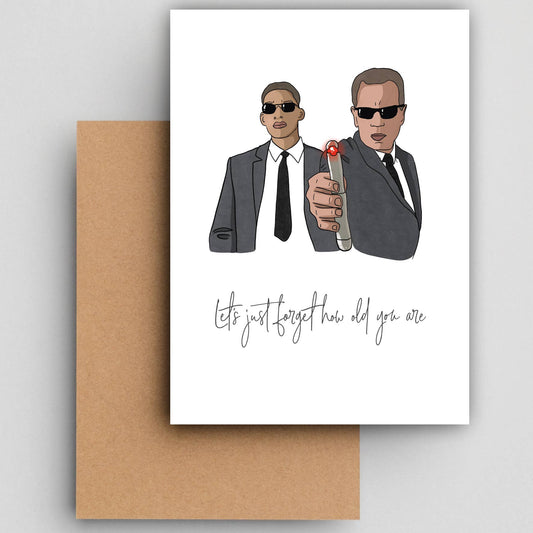 Wenskaart Men in black van Studio Raquelle: twee agenten in zwart pak met zonnebril en flitser, met de tekst Let's just forget how old you are